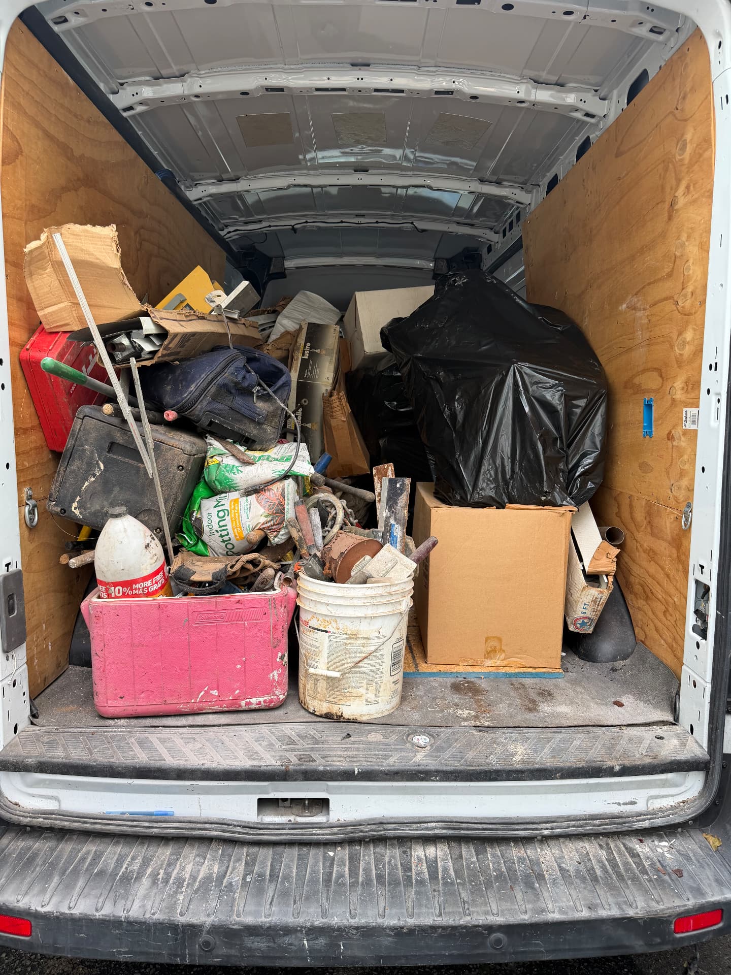 Tyler's cargo van loaded with boxes, bags and removed items
